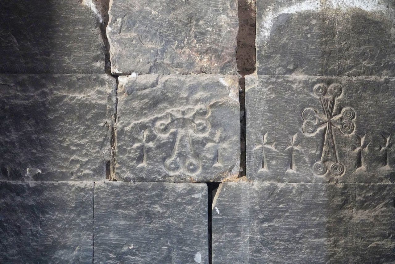 Ancient crosses carved into the stone wall