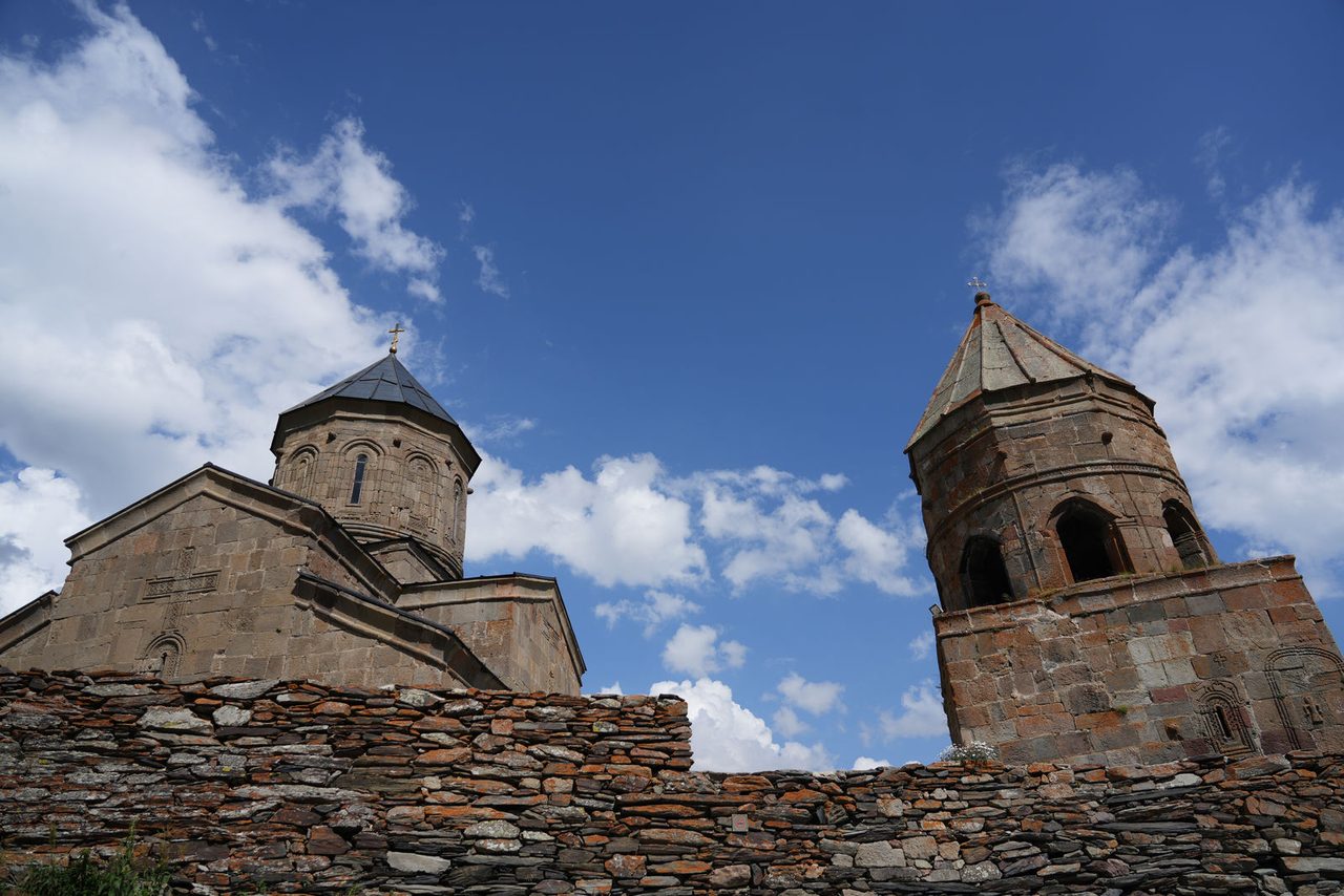 Stone walls and towers of Gergeti Trinity Church