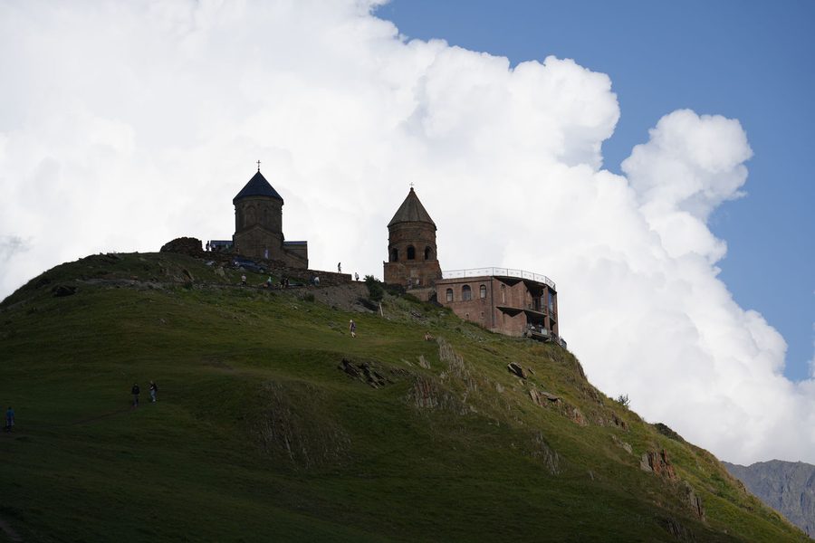 Looking up at Gergeti Trinity Church against the clouds