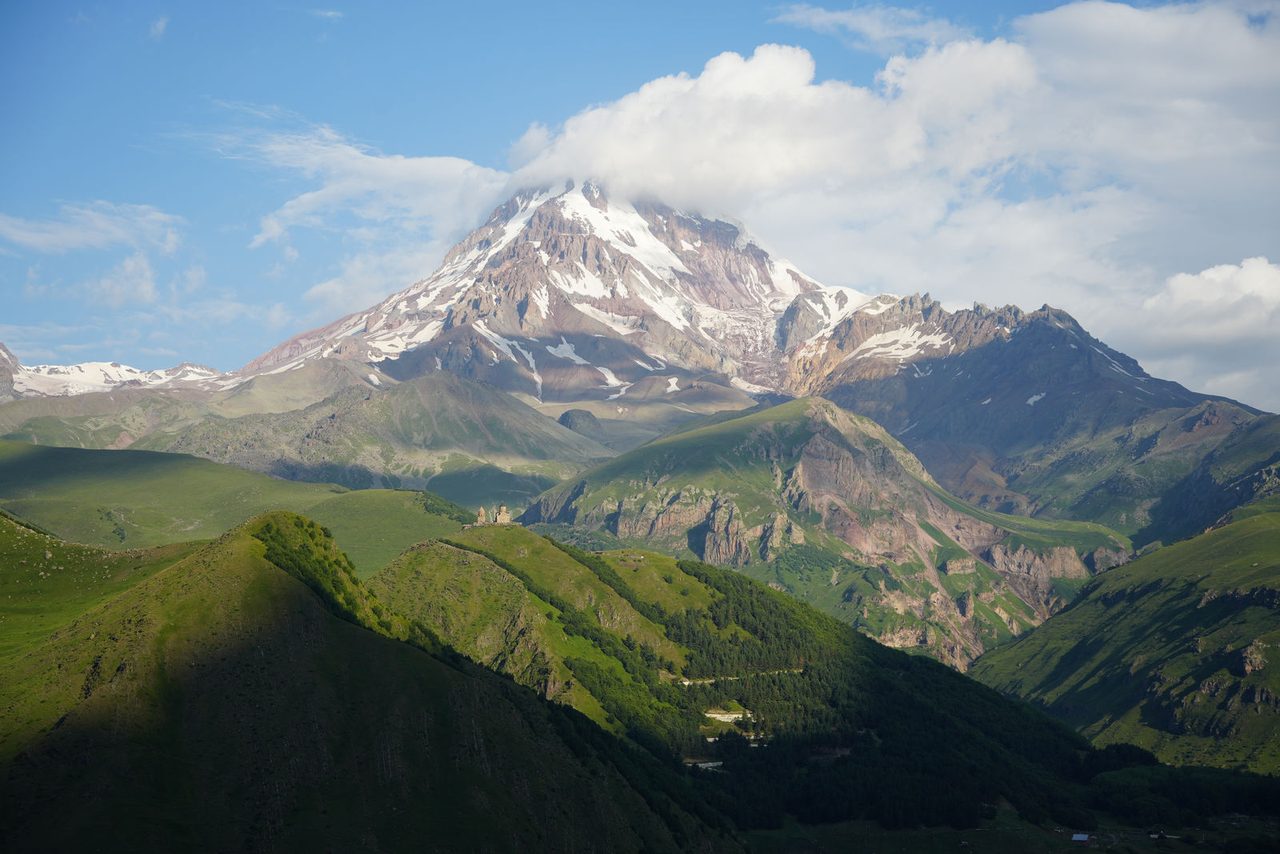 Mount Kazbek and the tiny Gergeti Trinity Church on the hill