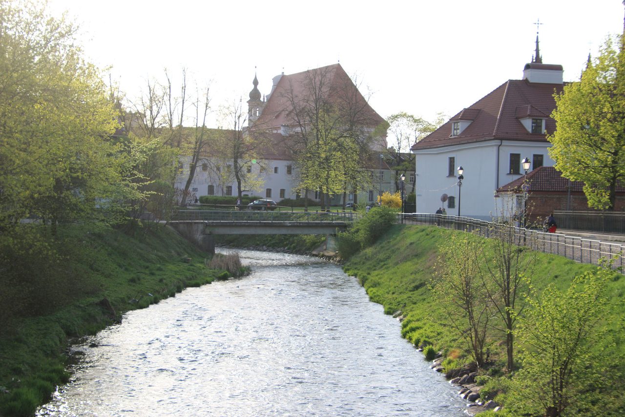 The Vilnia River flowing gently alongside the Bernardine Monastery ensemble