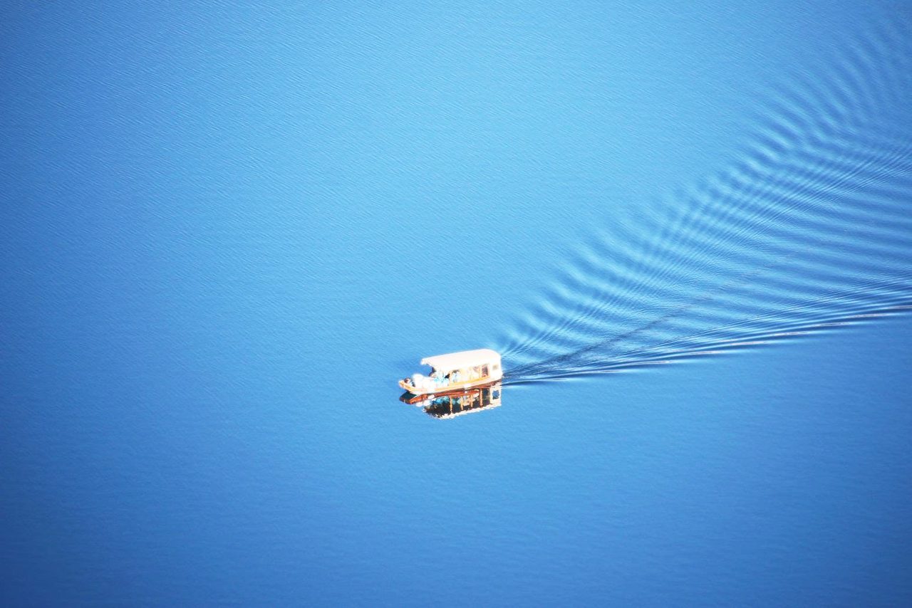 Traditional Pletna boat sailing on the blue water