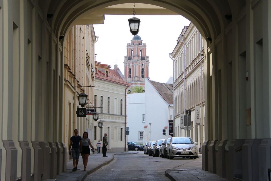 The bell tower of the Church of St Johns framed by an elegant archway