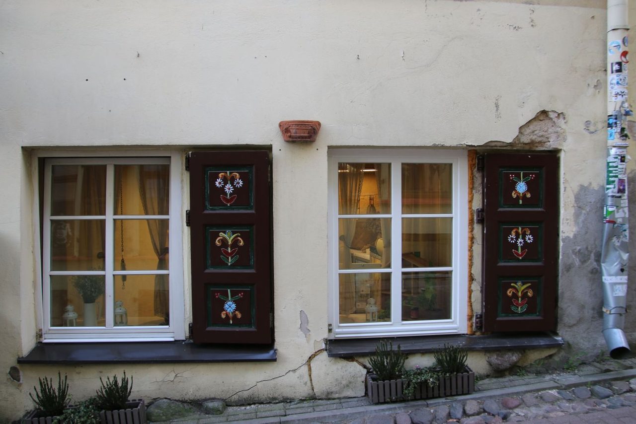 Traditionally painted flower motifs on wooden window shutters