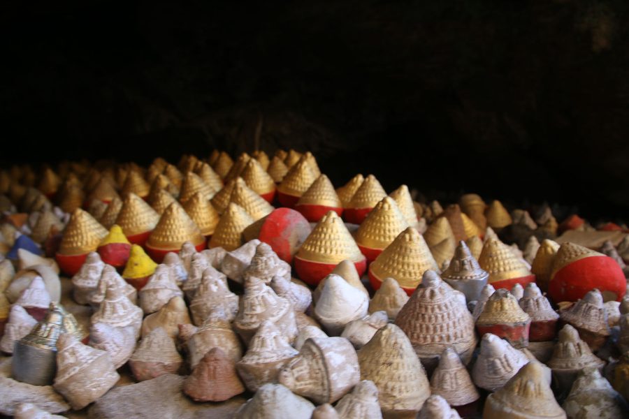 Traditional tsa-tsa clay offerings placed inside a sacred cave