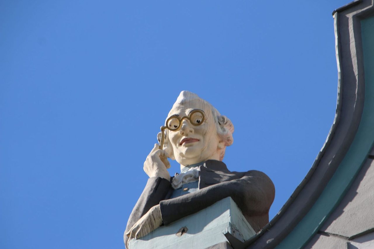 The glass-holding gentleman on the roof