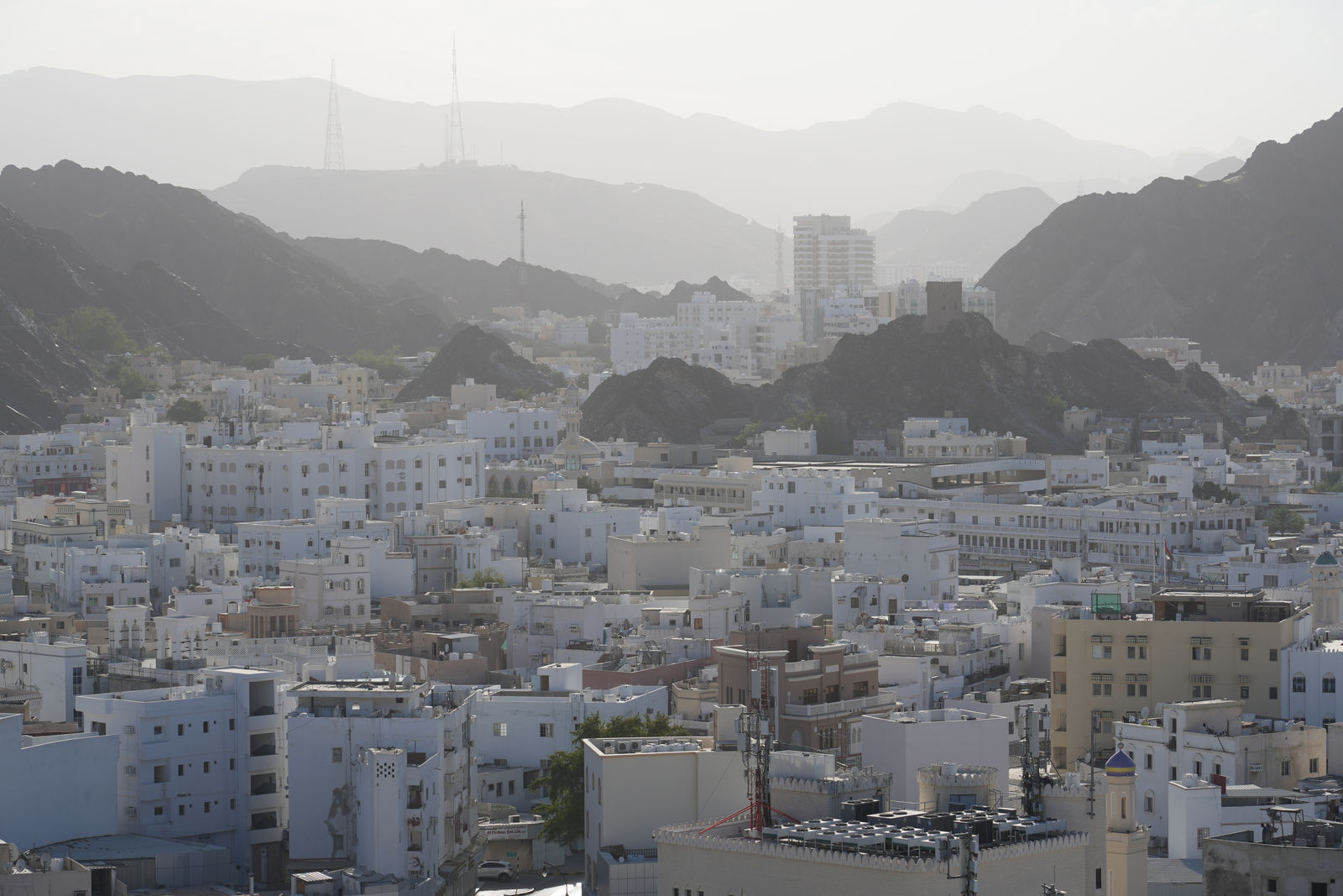 The Hazy Cityscape and Mountain Backdrop