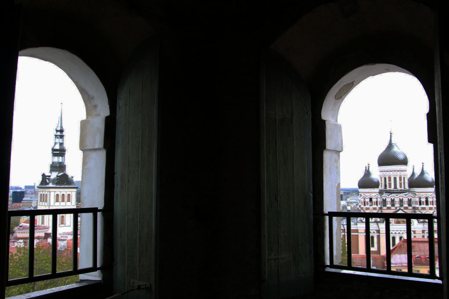 Two churches framed by old windows